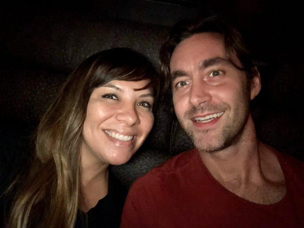 raquel & carl in a dark booth taking an usie