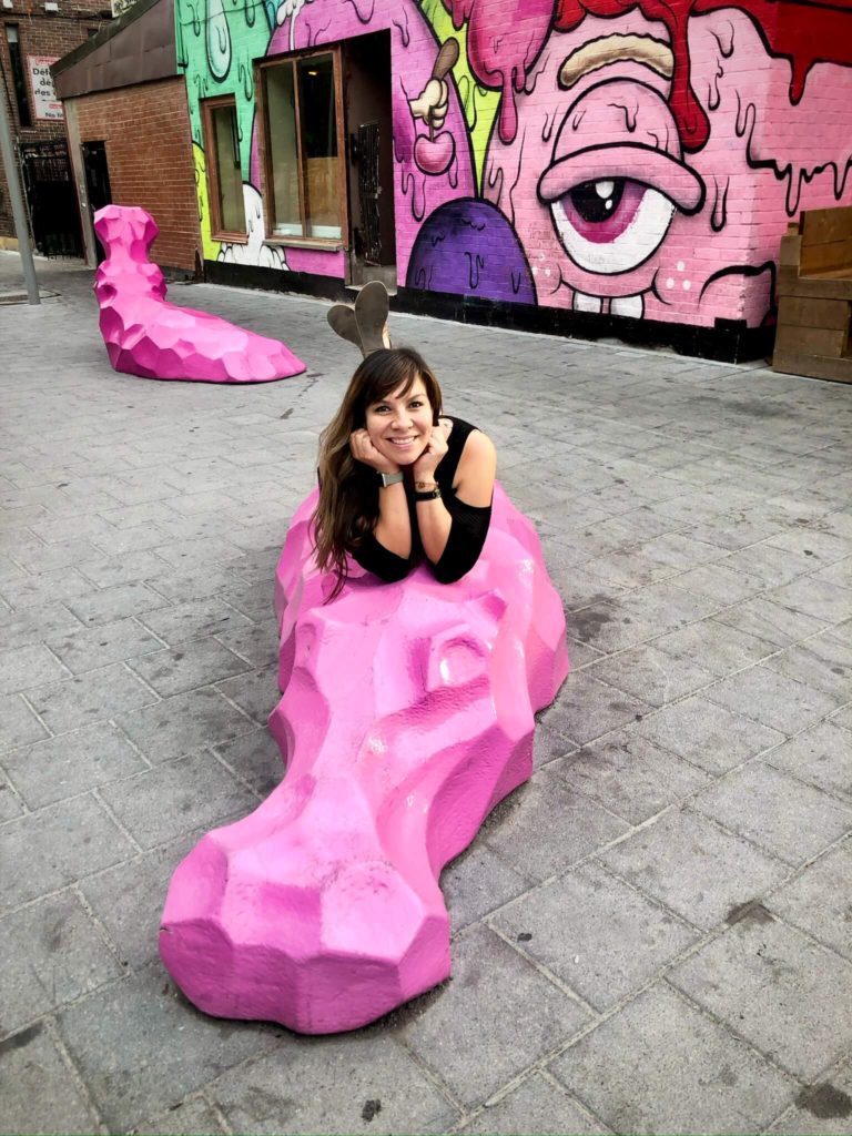 woman laying on pink hippo in montreal